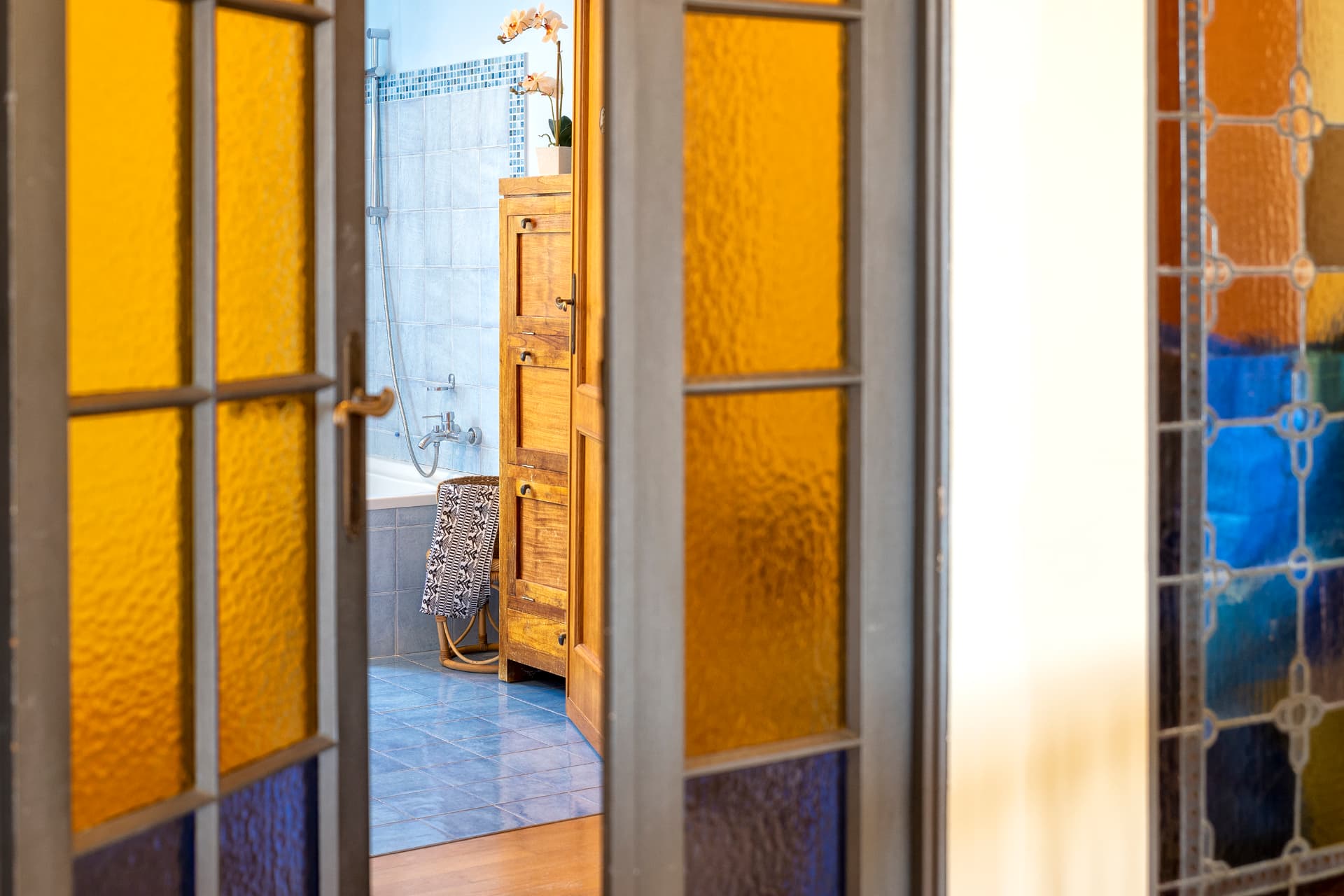 Il passaggio con vetrate colorate verso il bagno azzurro
